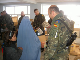 Soldados españoles repartiendo ayuda humanitaria a la población.