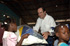 El ministro de Defensa, José Bono, durante su visita a Haití, hace entrega de un regalo a una niña que lo agradece con una sonrisa