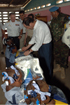 El ministro de Defensa, José Bono, entregando regalos a las niñas de un colegio, durante su visita a Haití