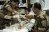 Los tenientes enfermeros Arévalo y Hossein realizan una cura de las quemaduras que padece el niño afgano Rached, en el destacamento español del PRT de Qala i Naw