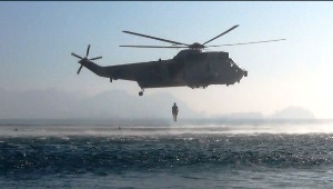 Unit divers junping from a helicopter
